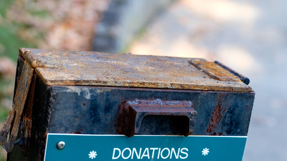 An outdoor metal donation box labeled "Donations Please Help"