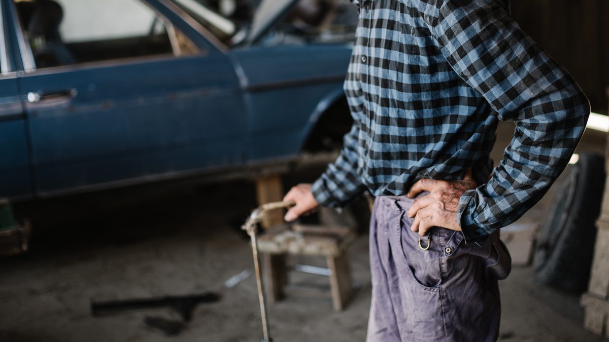 A man working on a car in a garage