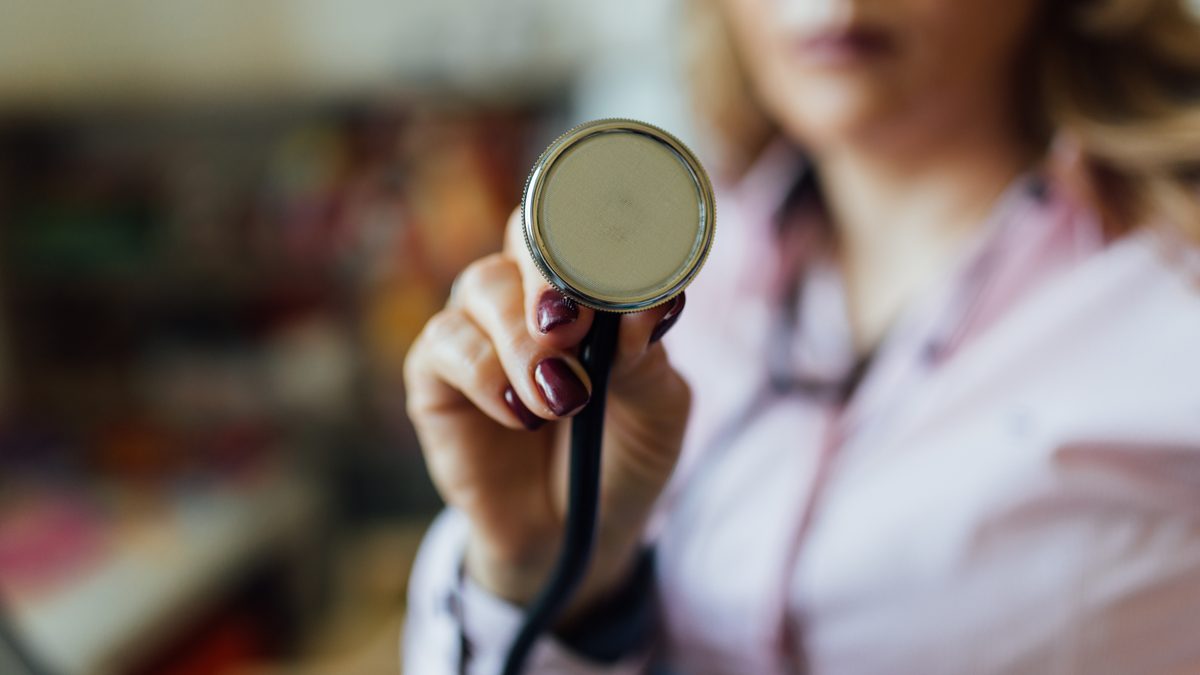 A stethoscope held in a hand