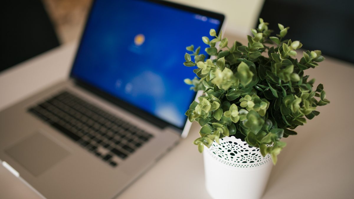 A laptop on a desk in a home workspace