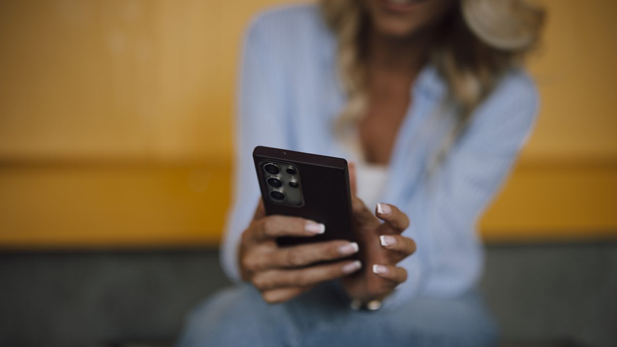 A woman looking at her phone in a relaxed home setting